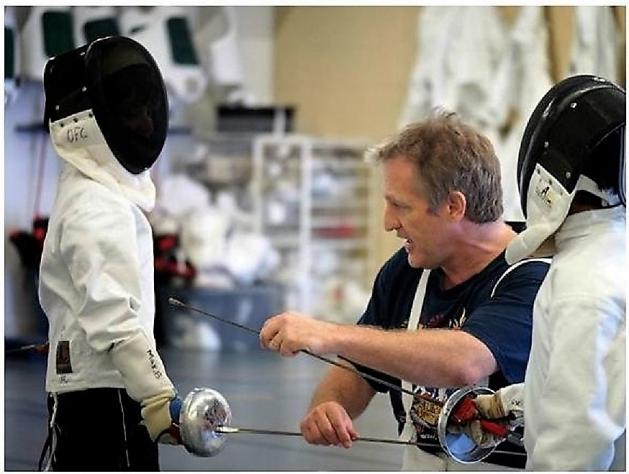 Fencing Coach teaching young musketeers